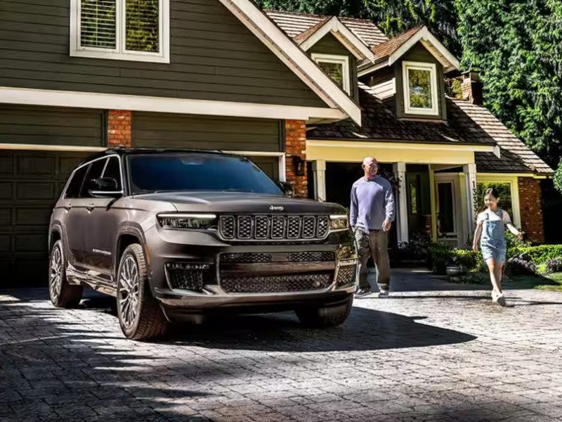 Father and daughter walking to get into their jeep